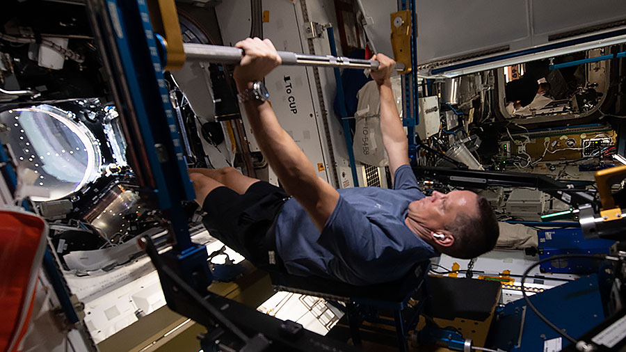 Astronaut Bob Hines works out on the space station's Advanced Resistive Exercise Device (ARED) that mimics lifting free weights on Earth.