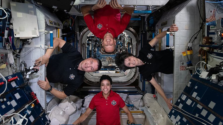 Expedition 67 astronauts (clockwise from bottom) Jessica Watkins, Kjell Lindgren, Bob Hines, and Samantha Cristoforetti, pose for a fun portrait inside their individual crew quarters.