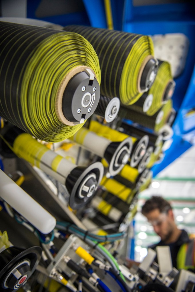 Close up image of spools of carbon fiber composite material are used for aircraft wing production.