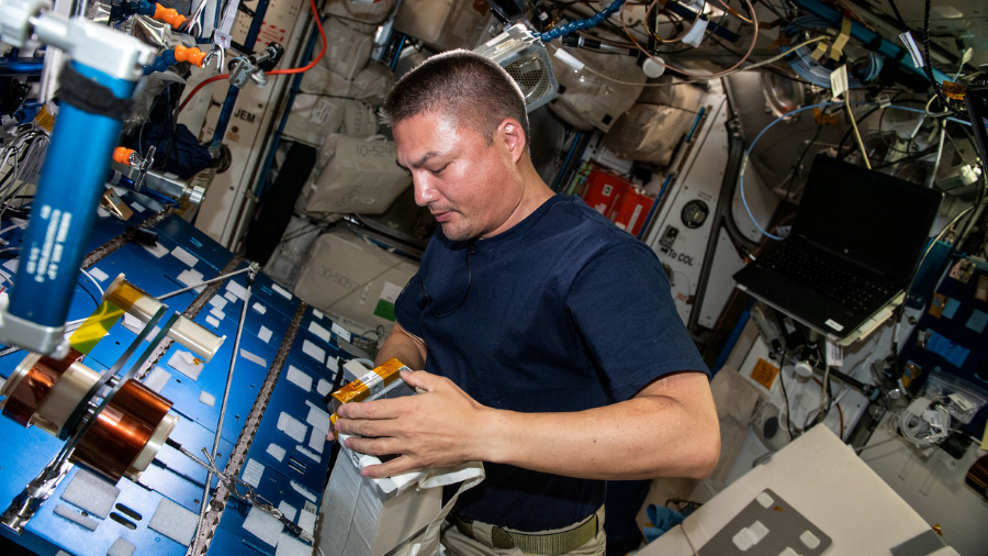 Expedition 67 Flight Engineer and NASA astronaut Kjell Lindgren checks airflow and water absorption capabilities on spacesuit components at the maintenance work area inside the International Space Station's Harmony module on May 20, 2022.