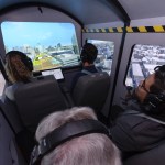 Air taxi demonstration participants looking at screens showing vertiport configuration