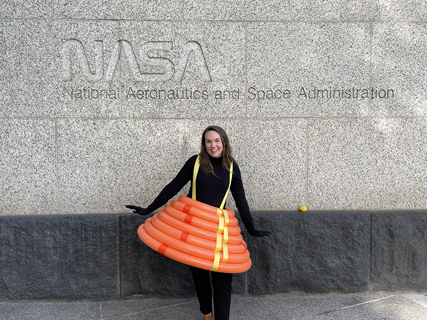 Woman standing in front of NASA in a LOFTID costume.