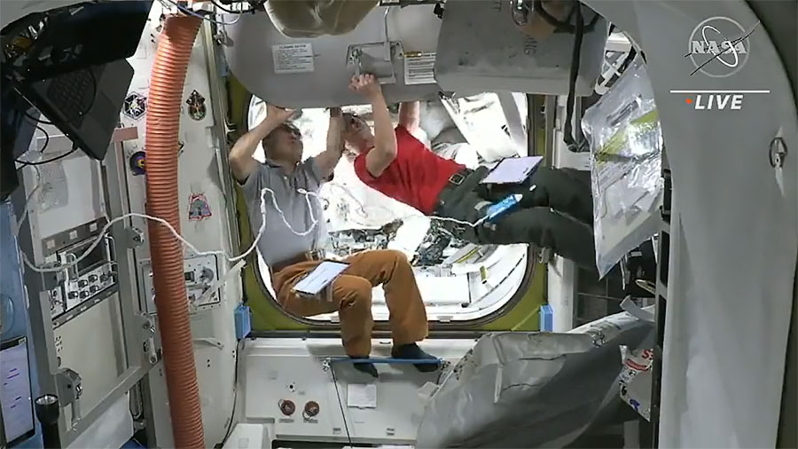 Astronauts Koichi Wakata and Nicole Mann close the hatch to the Quest airlock where astronauts Josh Cassada and Frank Rubio are positioned to begin a spacewalk. Credit: NASA TV