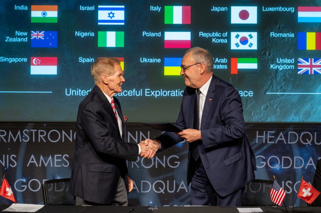 Swiss Federal Councillor Guy Parmelin, right, shakes hands with NASA Administrator Bill Nelson, left, after signing the Artemis Accords, Monday, April 15, 2024, at the Mary W. Jackson NASA Headquarters building in Washington.