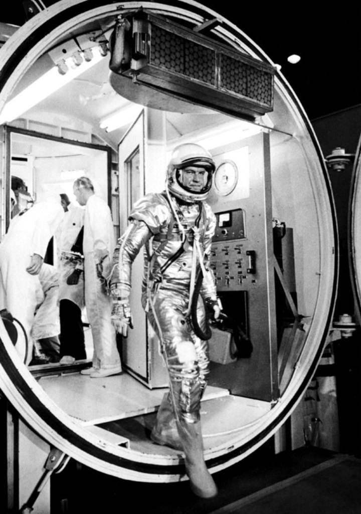 Gordon Cooper leaves the Hangar S altitude chamber wearing his astronaut suit.