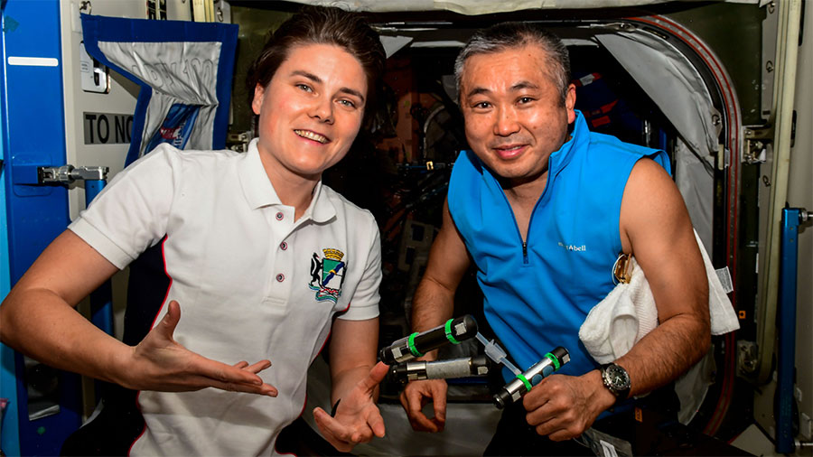 Expedition 68 Flight Engineers Anna Kikina and Koichi Wakata pose together aboard the space station. Credit: Roscosmos