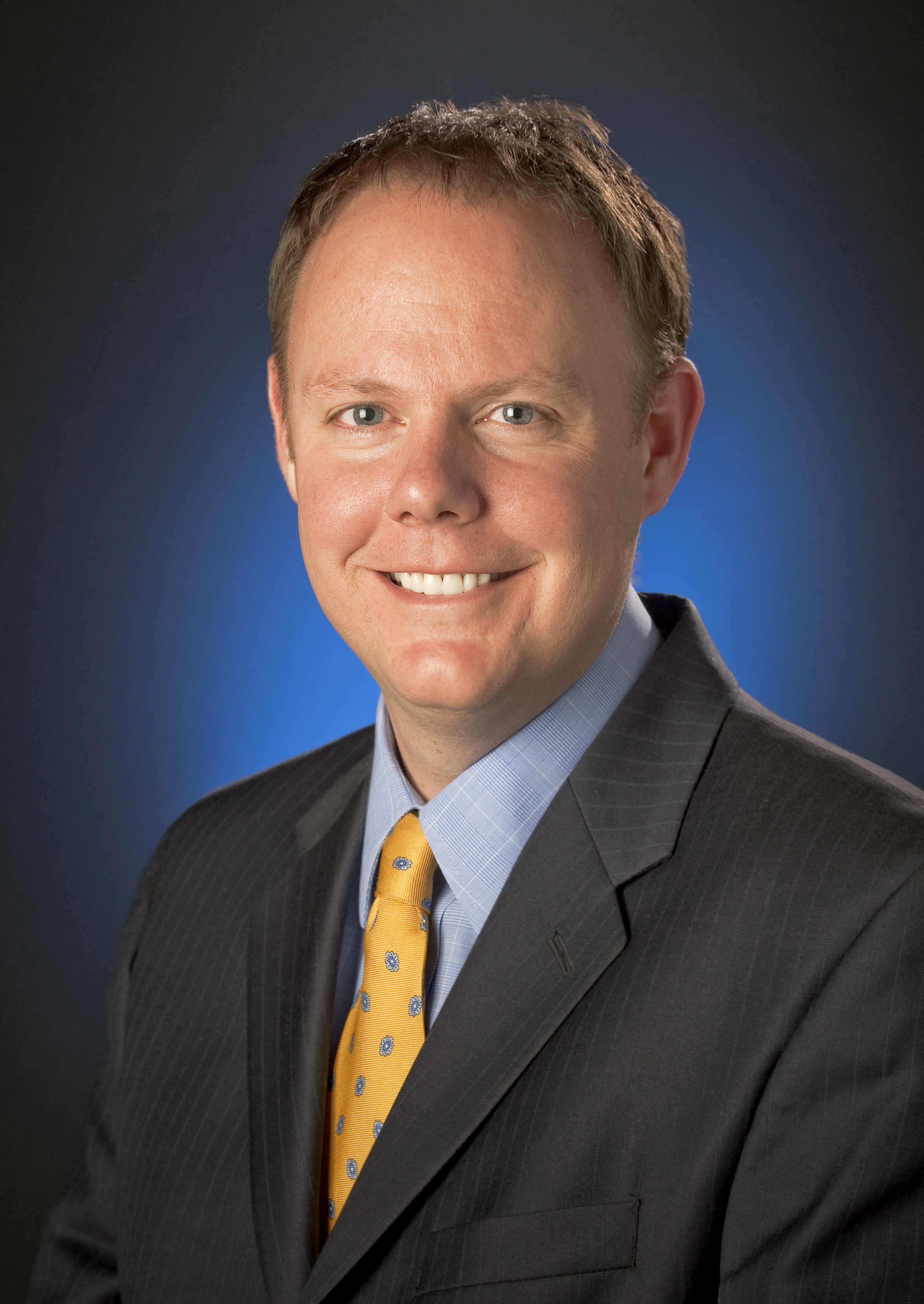 Jon Montgomery, wearing a suit and a yellow tie. 