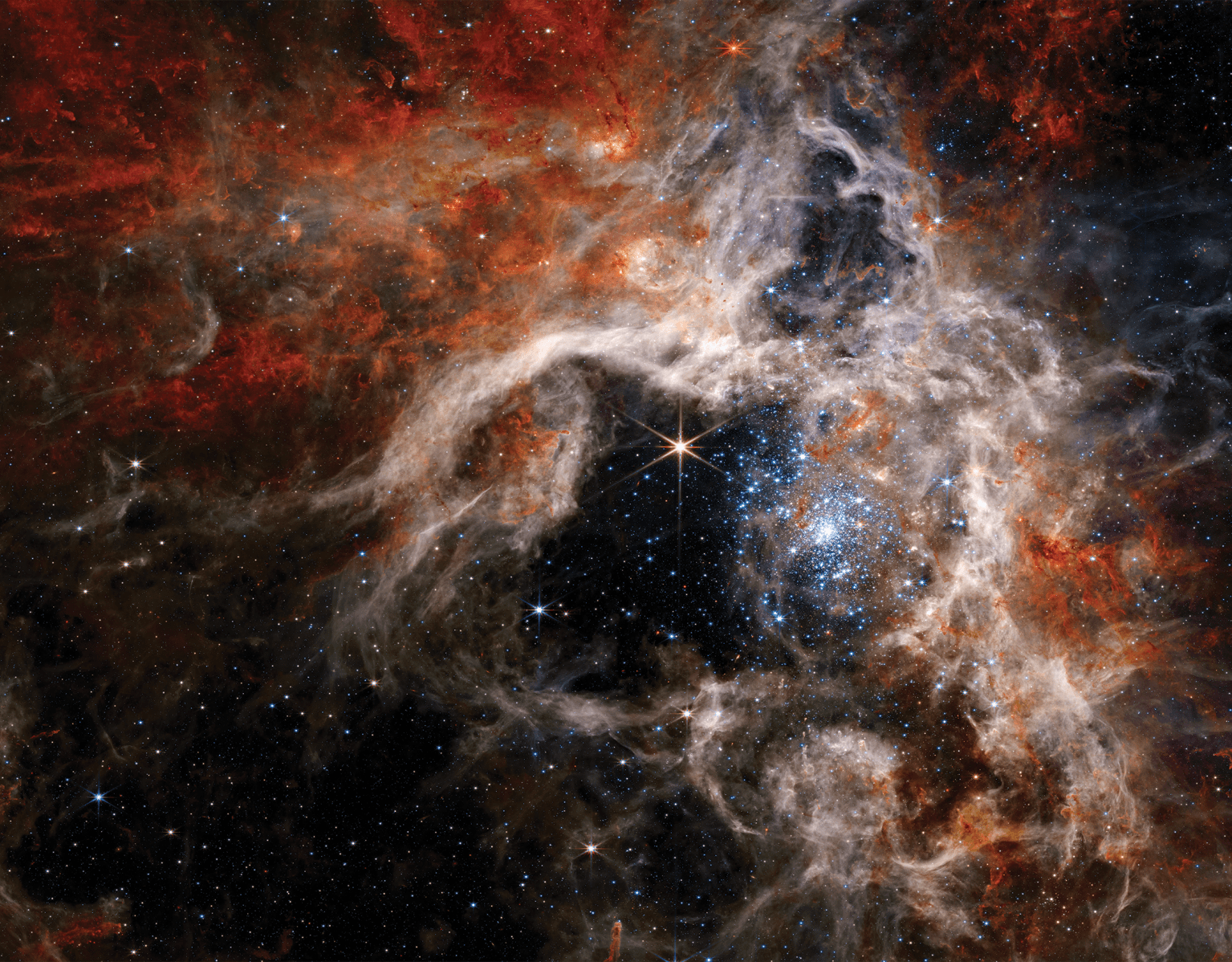 带有星星和彩色橙色、红色和白色漩涡的太空图像。