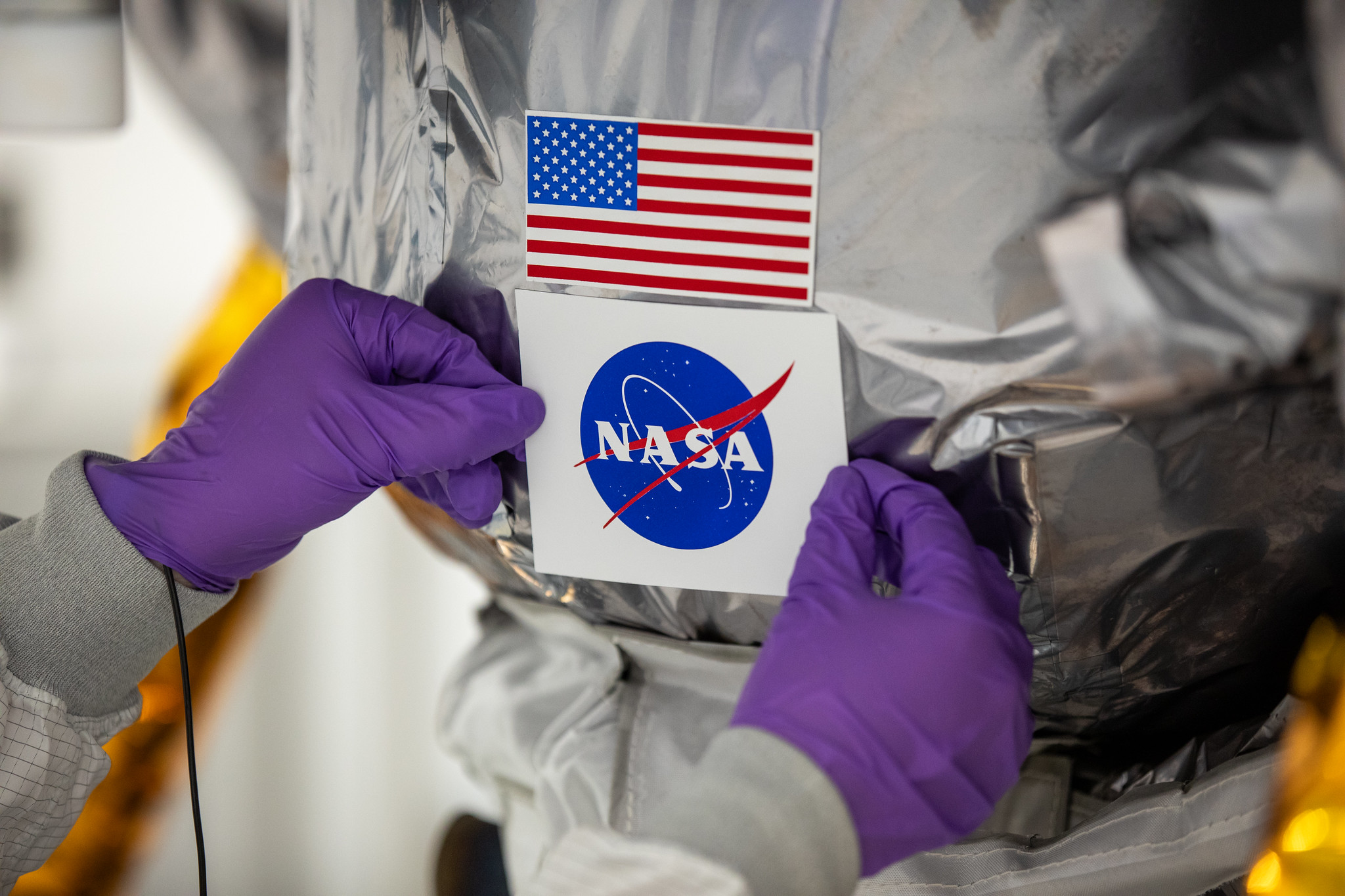 Teams with Astrobotic install the NASA meatball decal on Astrobotic’s Peregrine lunar lander on Tuesday, Nov. 14, 2023, at the Astrotech Space Operations Facility near the agency’s Kennedy Space Center in Florida.
