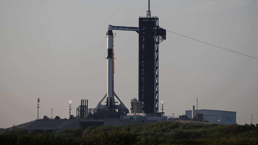 The SpaceX Falcon 9 rocket with the Crew Dragon Endeavour atop stands at the Kennedy Space Center launch pad counting down to a lift off at 1:45 a.m. EST on Monday.