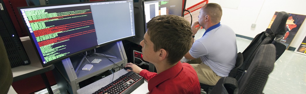 Employees in front of a computer <a href=