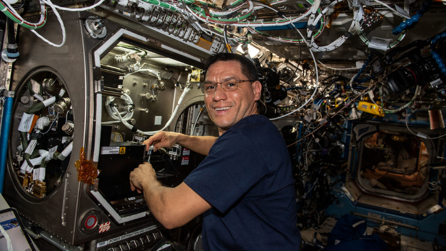 NASA astronaut and Expedition 68 Flight Engineer Frank Rubio sets up the new Particle Vibration experiment inside the Destiny laboratory moduleâs Microgravity Science Glovebox on Feb. 3, 2023. The physics study will investigate how particles organize themselves in fluids possibly advancing manufacturing techniques and providing new insights on astrophysics.