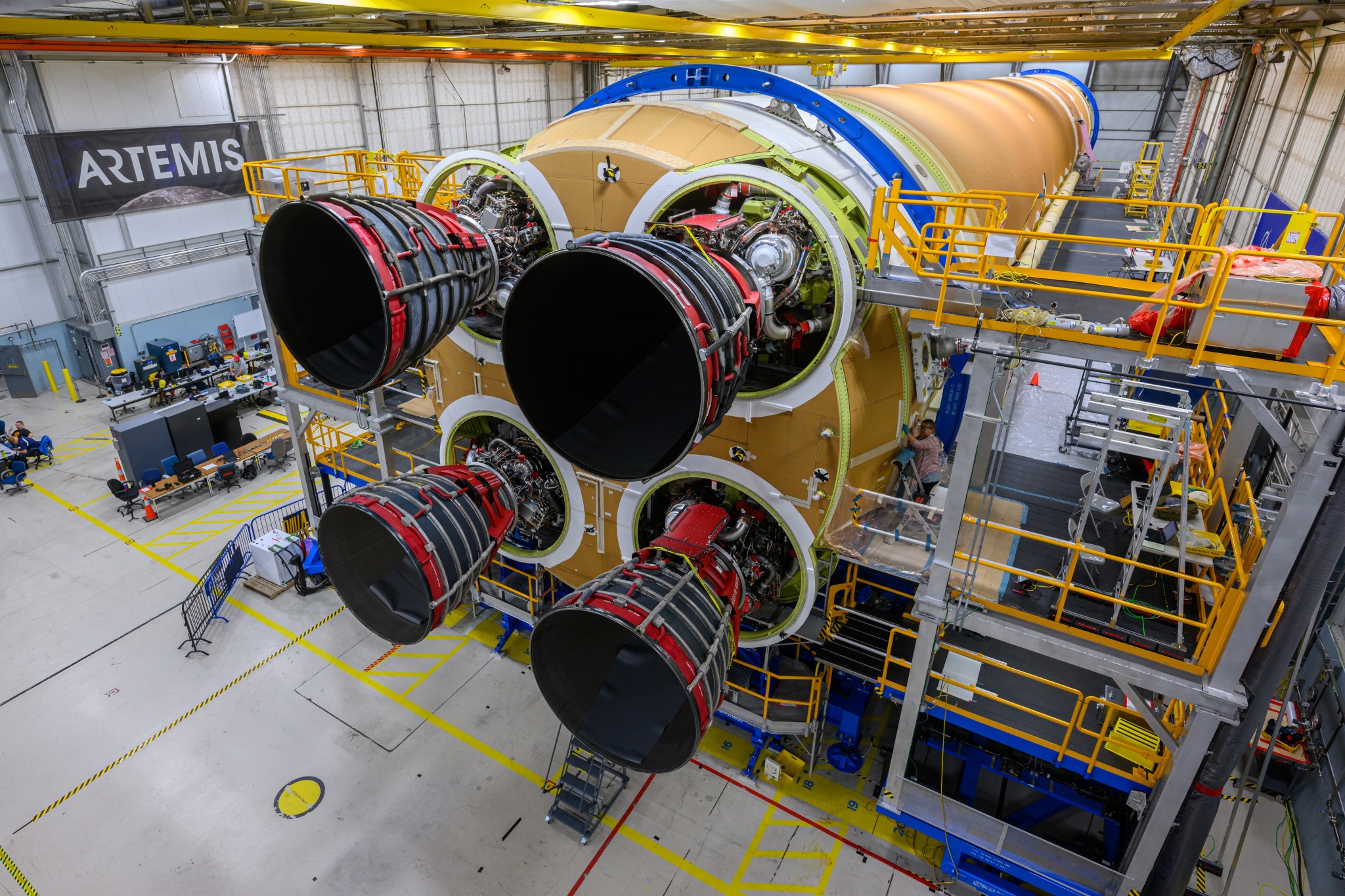 Engineers and technicians from NASA, Aerojet Rocketdyne, and Boeing at NASA’s Michoud Assembly Facility in New Orleans have installed all four RS-25 engines to the core stage for NASA’s Space Launch System rocket that will help power the first crewed Artemis mission to the Moon. The yellow core stage is seen in a horizontal position in the final assembly area at Michoud. The engines are arranged at the bottom of the rocket stage in a square pattern, like legs on a table. 