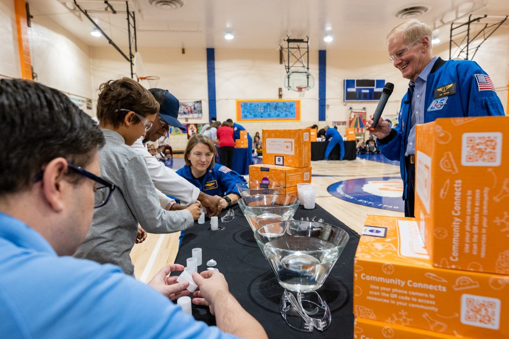 NASA Administrator Bill Nelson, right, and NASA’s SpaceX Crew-3 astronaut Kayla Barron, left, perform a STEM demonstration at Amidon-Bowen Elementary School in Washington, D.C., in December 2022. Students received NASA Learning Lunchboxes developed by Center of Science and Industry in Columbus, Ohio.