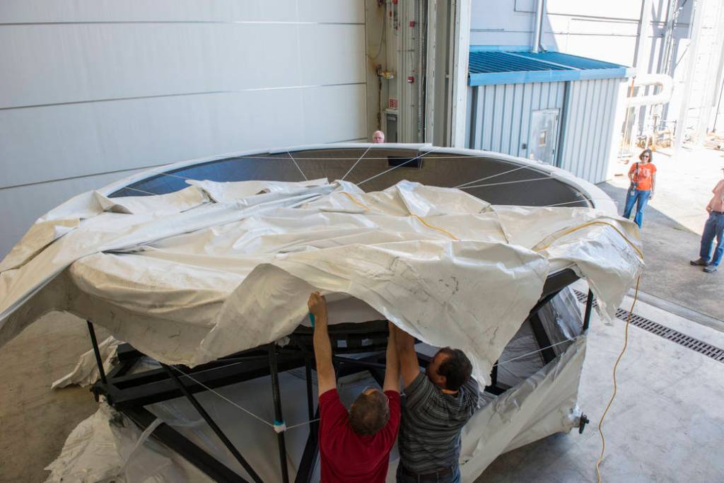 Engineers at NASA's Marshall Space Flight Center unwrap the adapter diaphragm Sept. 27, 2013.