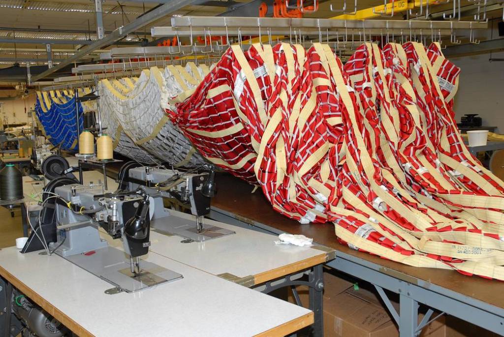 In the Parachute Refurbishment Facility at NASA's Kennedy Space Center, parachutes for the Ares rocket are prepared for packing.