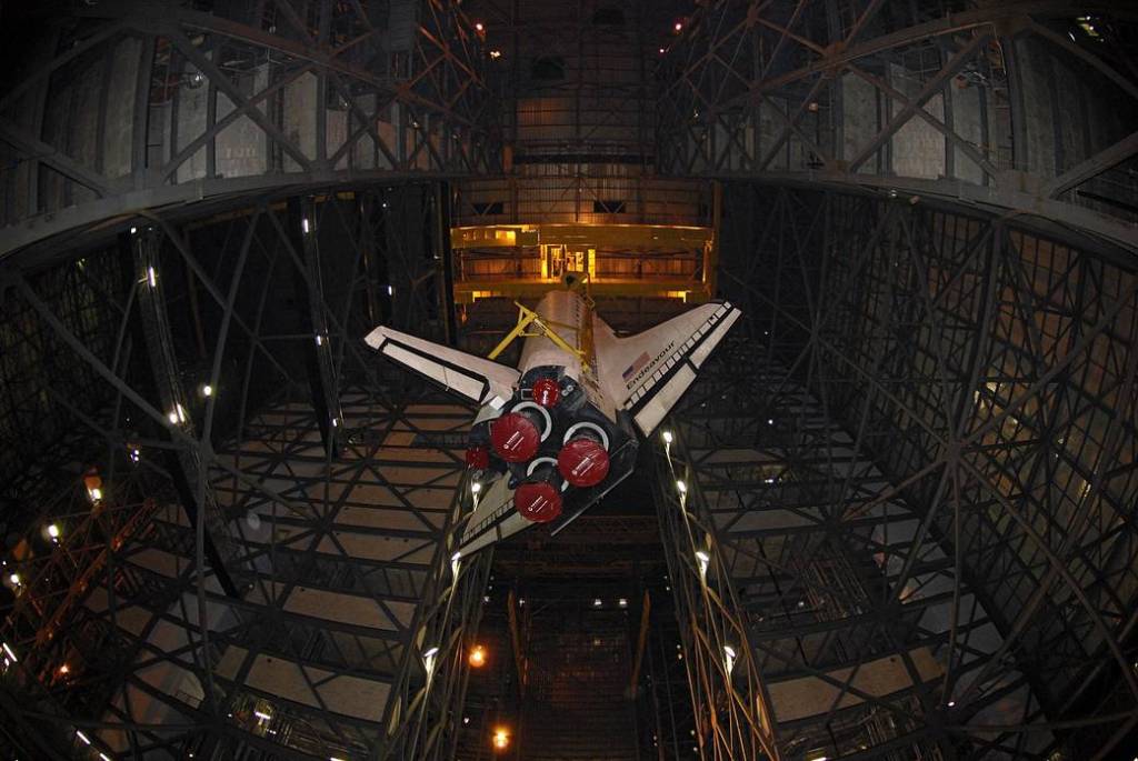 Inside the giant Vehicle Assembly Building at NASA’s Kennedy Space Center in Florida, space shuttle Endeavour is slowly lowered into high bay 1 where it will be joined with its external fuel tank and solid rocket boosters.