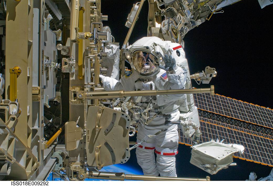 Spacewalking astronaut outside International Space Station