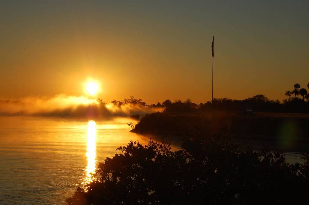 The fog clears from the turn basin as the morning sky turns blue over NASA's Kennedy Space Center in Florida.