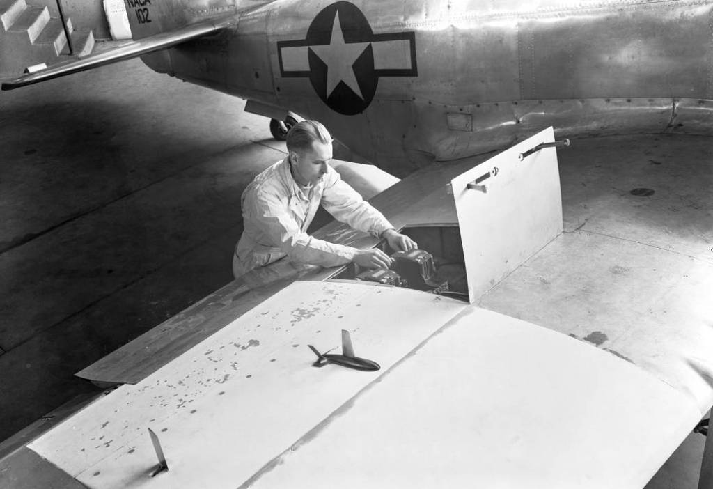 A semispan airplane model and flow-direction vane mounted on the wing of a P-51D airplane for transonic tests by wing-flow metho