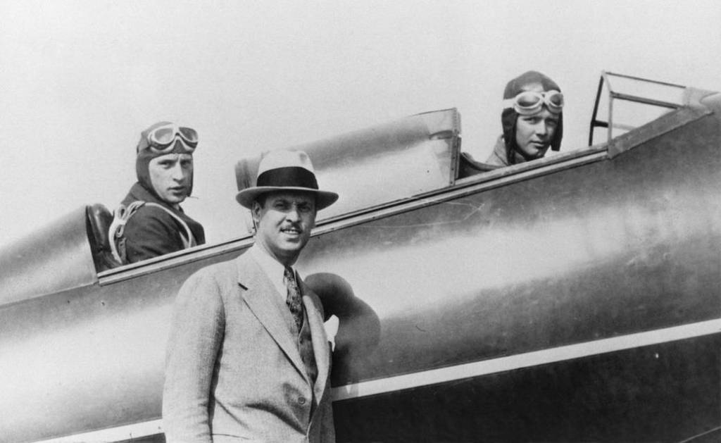 Fred E. Weick, rear cockpit; aviator Charles Lindberg, front cockpit and Tom Hamilton, standing.