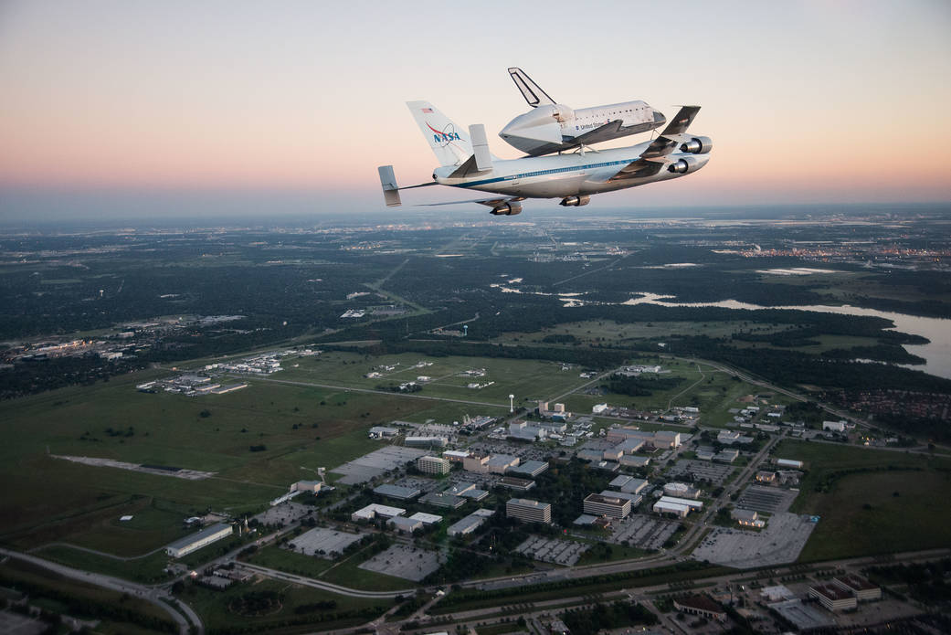 Space Shuttle Endeavour being ferried by NASA's Shuttle Carrier Aircraft flies over the Johnson Space Center in Houston on its way to the California Science Center for display.