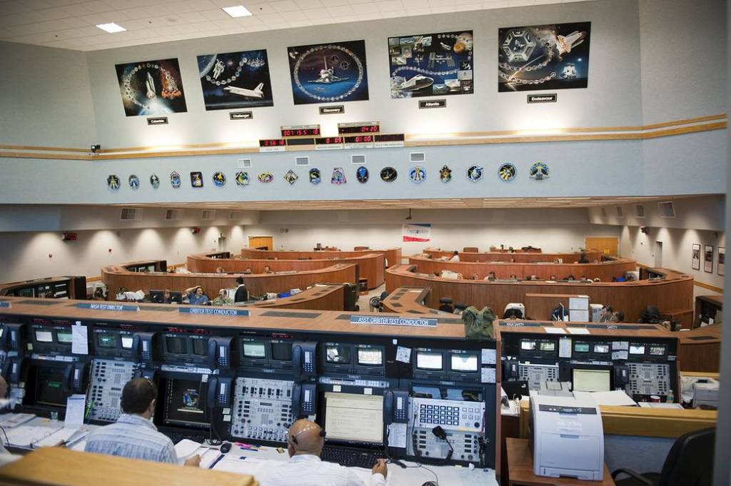 In Firing Room 4 of the Launch Control Center at Kennedy Space Center, STS-133's launch team members rehearse procedures for the liftoff of space shuttle Discovery's final mission