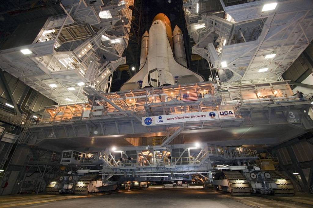 Xenon lights illuminate space shuttle Discovery as it rolls from the Vehicle Assembly Building to Launch Pad 39A at NASA's Kennedy Space Center in Florida. 