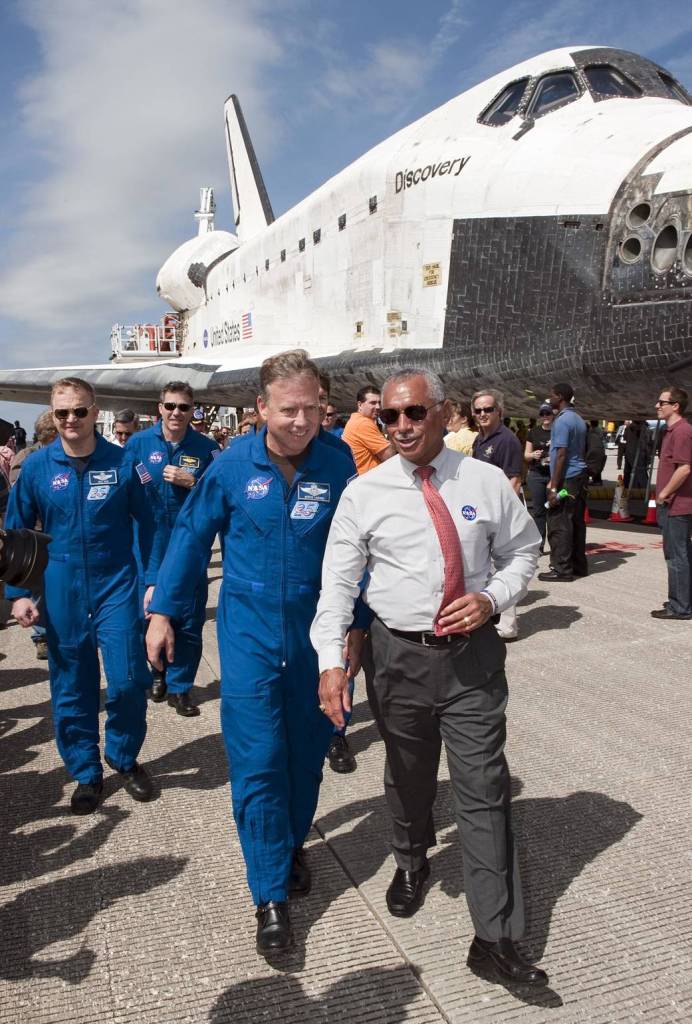 NASA Administrator Charlie Bolden leads the STS-133 crew to media representatives waiting on the Shuttle Landing Facility to hear statements about space shuttle Discovery's final spaceflight mission.