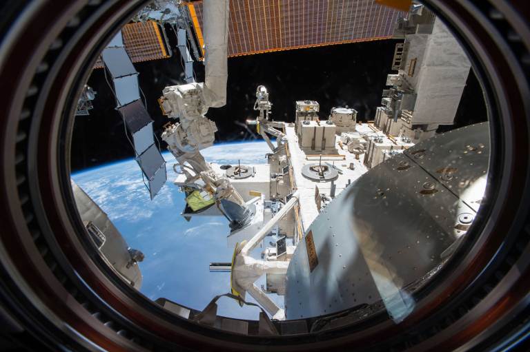 The Nanoracks External Platform seen through a window onboard the ISS.