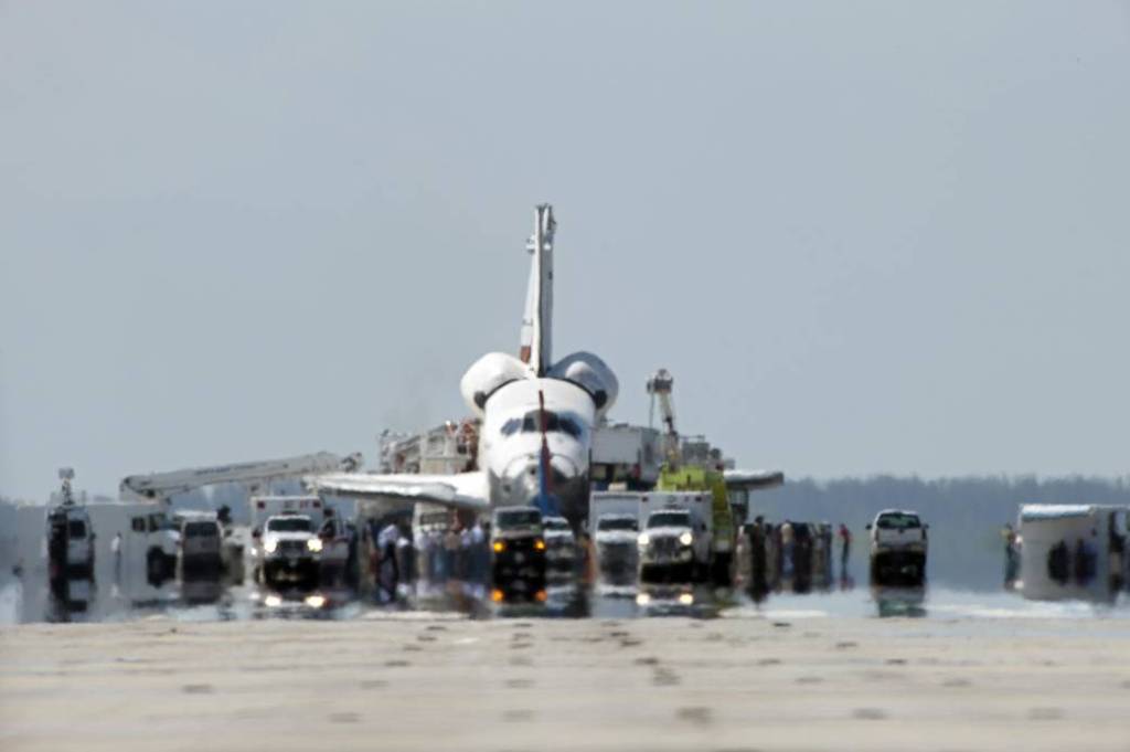 A convoy of safing and emergency vehicles meet space shuttle Atlantis on Runway 33 at the Shuttle Landing Facility at NASA's Kennedy Space Center in Florida.