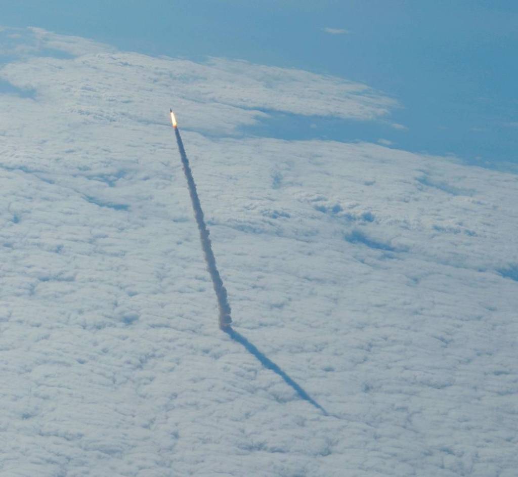 Photographed from a shuttle training aircraft, space shuttle Endeavour and its six-member STS-134 crew head toward Earth orbit and a rendezvous with the International Space Station. 