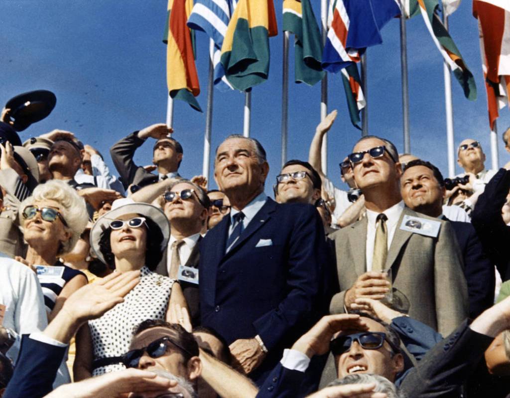 Vice President Spiro Agnew (right center) and former President Lyndon Johnson (left center) view the liftoff of Apollo 11 from the stands located at the Kennedy Space Center VIP viewing site. 