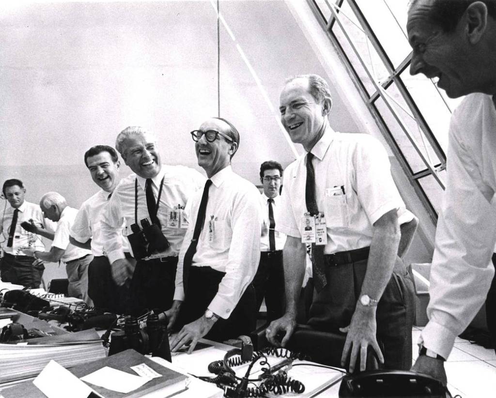 Apollo 11 mission officials relax in the Launch Control Center following the successful liftoff of Apollo 11. 