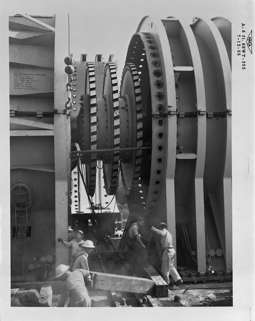 men working on construction of 3-stage compressor