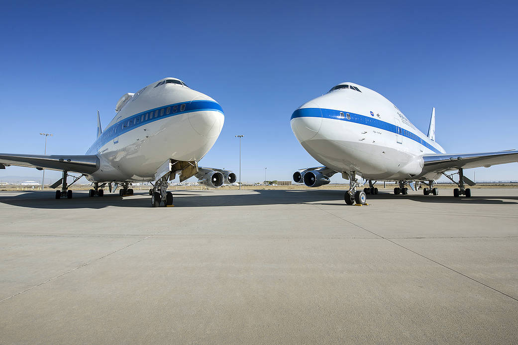 SOFIA) and the Pratt and Whitney Canada 747SP testbed sit nose-to-nose at NASA Armstrong Flight Research Center’s Building 703 i