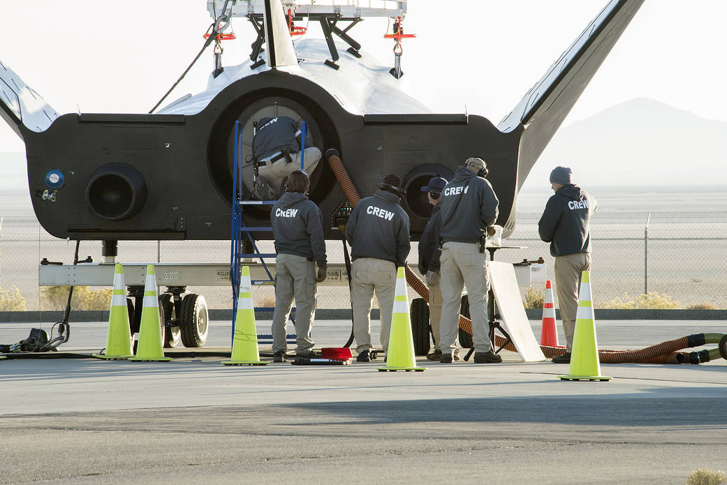 Sierra Nevada Corp’s Dream Chaser crew attached the wires that the helicopter would use to pick it up.