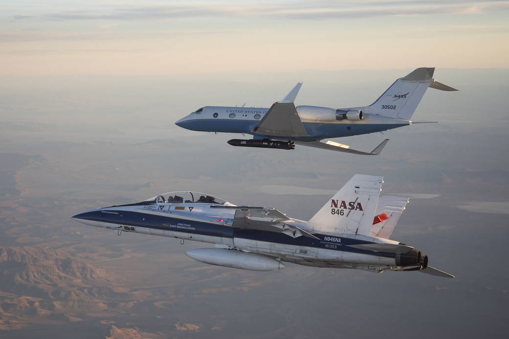 NASA’s C-20A with Generation Orbit’s hypersonic testbed attached is chased by the agency’s F-18 jet for safety and photography.