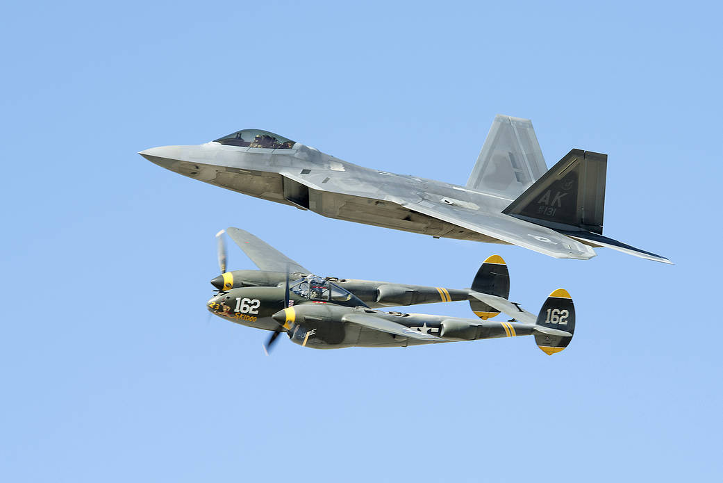 The F-22 and the classic P-38 shares the sky at the Los Angeles County Air Show in Lancaster, California.
