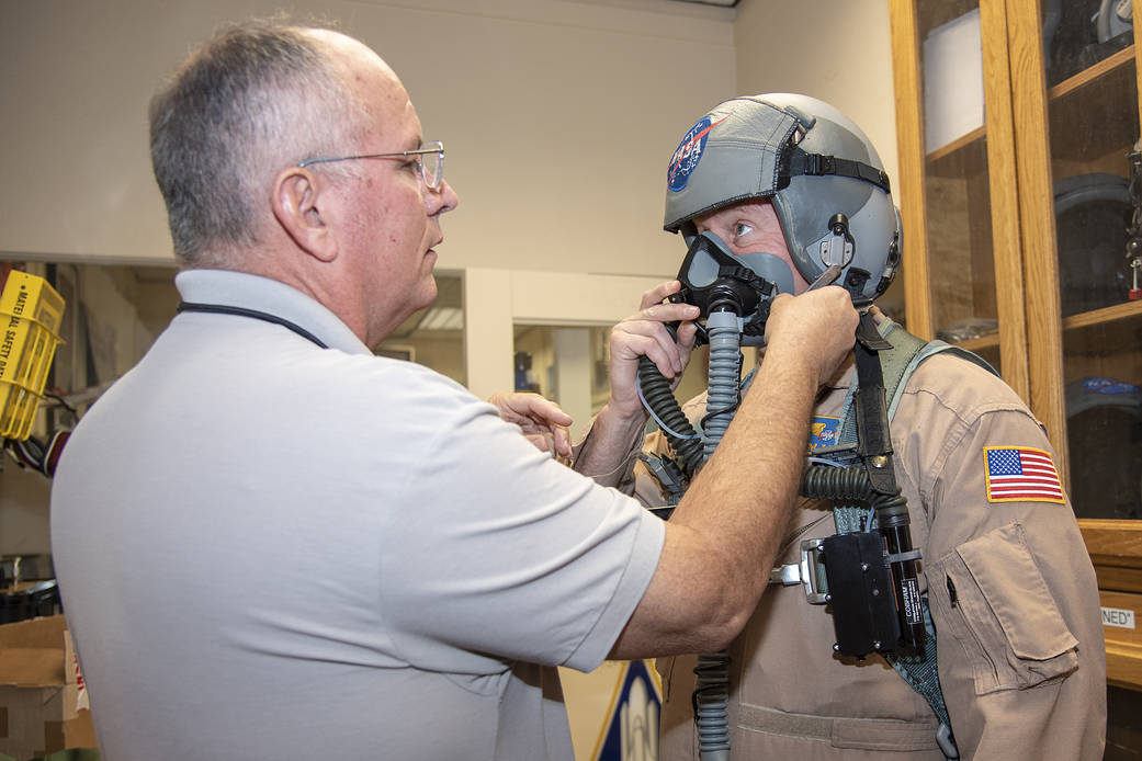 NASA pilot Jim Less is assisted by life support as he is fitted with a Cobham designed VigiLOX pilot oxygen monitoring system. 