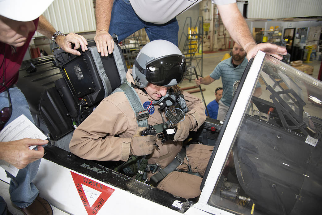 NASA pilot Jim Less sits in the cockpit of a NASA F/A-18 aircraft.