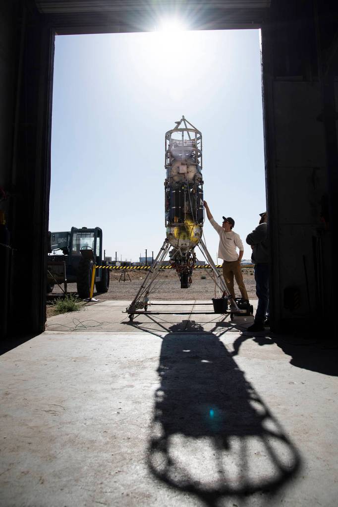 Technicians from Masten Space Systems inspecting the Xodiac rocket.