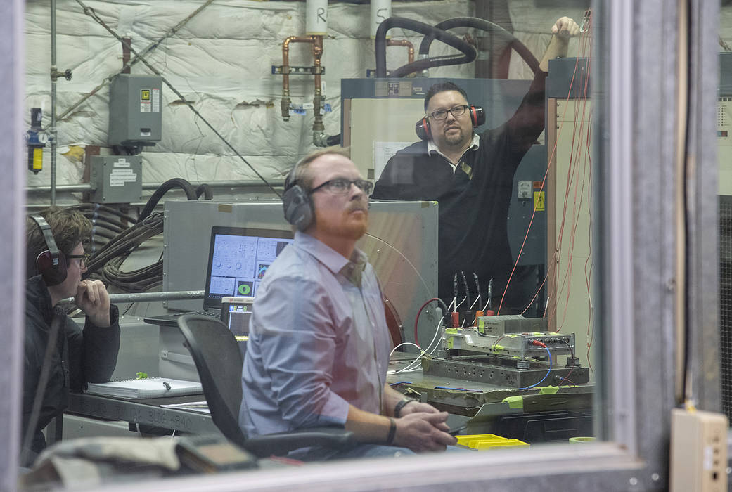 Engineers monitor data during vibration testing of a cruise motor controller for the X-57 Maxwell.