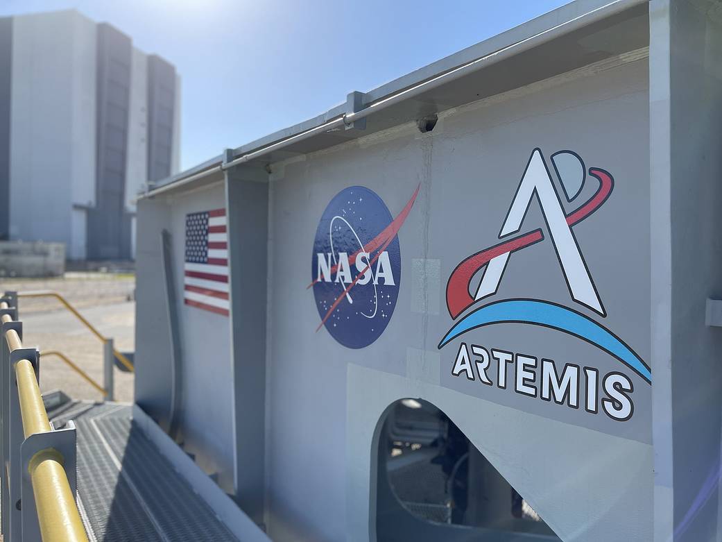 The crawler-transporter for Artemis I is in view sporting 8 new Artemis logos.