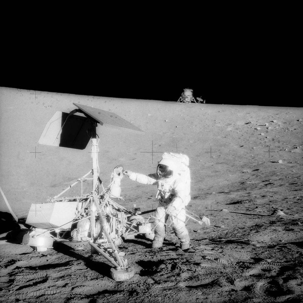 This striking image, captured during the second Apollo 12 extravehicular activity (EVA), depicts two U.S. spacecraft.