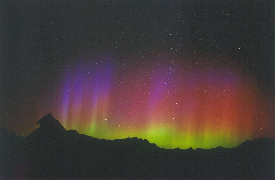 The annual Perseid meteor shower in 2002 could be seen through a colorful auroral glow.