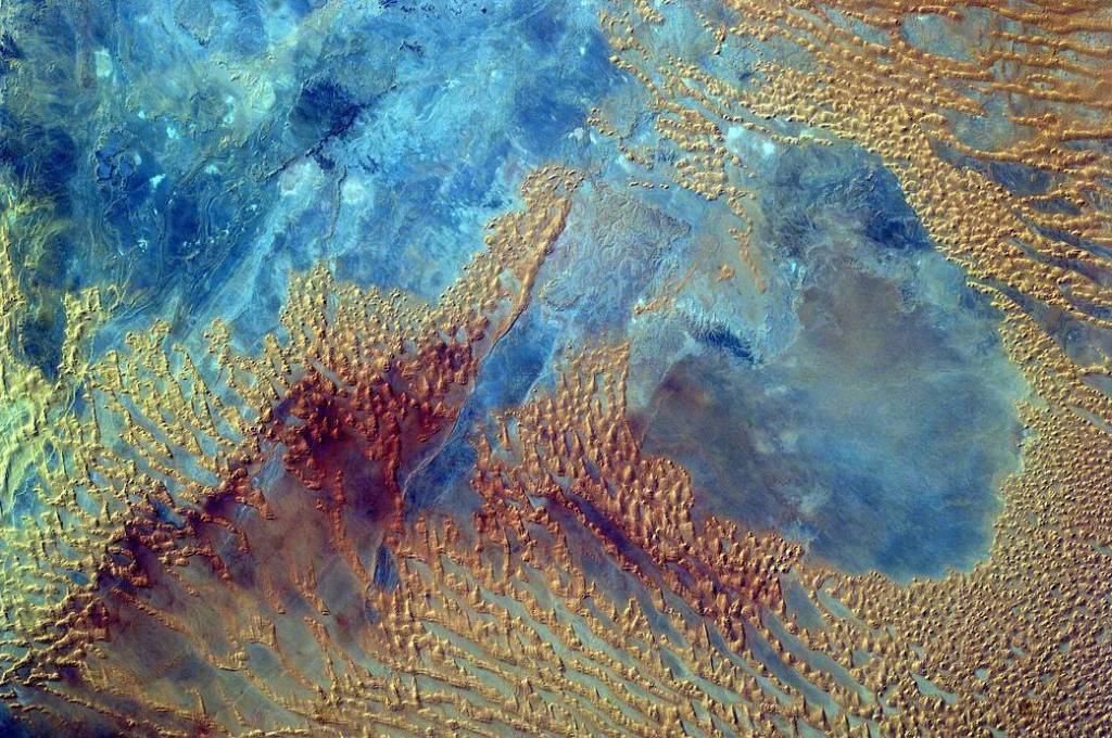 Bright colored formations in Sahara Desert imaged from low Earth orbit