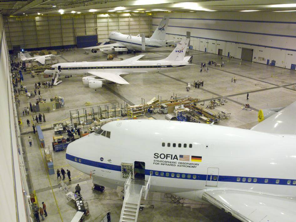 Several NASA science aircraft, including (from bottom) the SOFIA observatory, the DC-8 airborne laboratory and an ER-2 high-alti