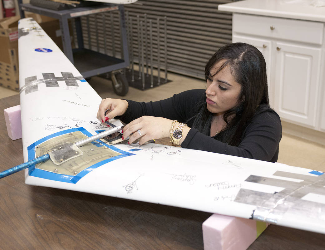 Intern Adjusts iPhone Mount on Prandtl-D Radio-controlled Flying Wing