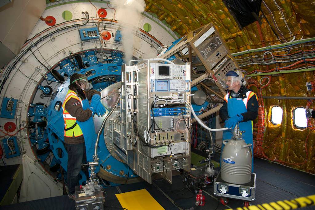 Christophe Risacher (left) and Karl Jacobs cool the GREAT spectrometer with a liquid cryogen in preparation for a flight of the 